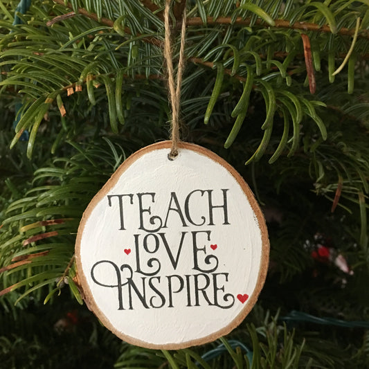 Teacher ornament is crafted from birch wood.Measures about 2.5-3.5 inches in diameter (no 2 are the same).Background hand-painted in white. Saying Teach Love Inspire in gray with red heart accents. Jute rope attached for easy hanging.