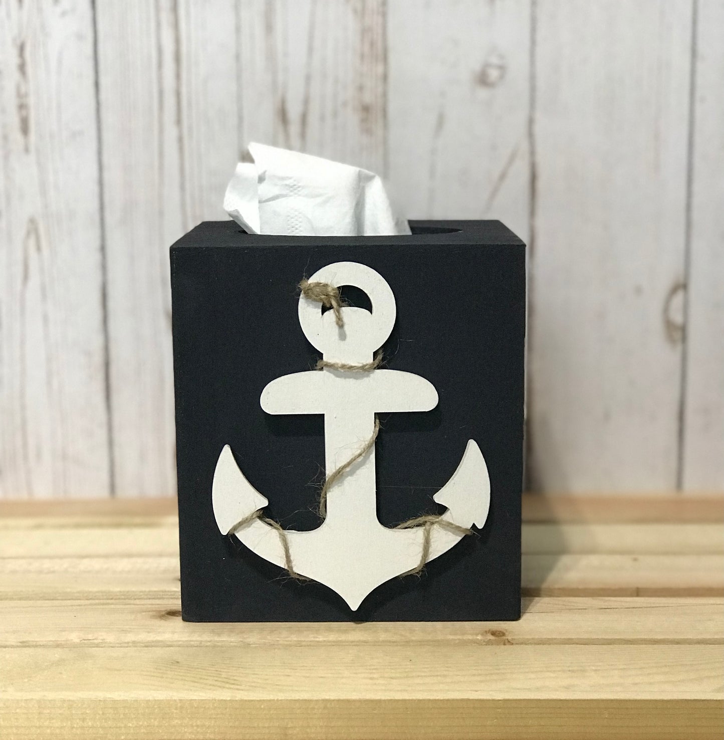 Square wood box Measures 5.75 inch x 5.25 inch Fits standard size facial tissue box. (not included) Hand painted in navy blue. Wooden anchor cutout is painted in white with jute rope running through it on one side only. 