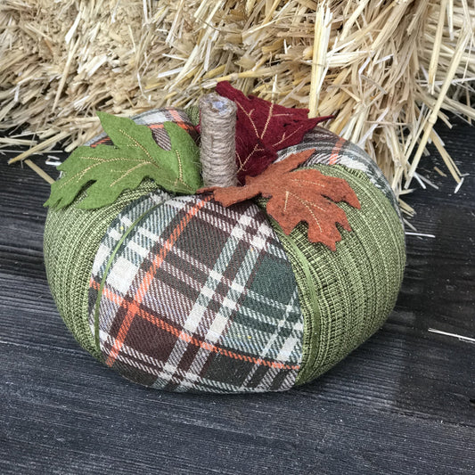 Green Plaid Pumpkin is a fabric pumpkin in shades of orange, green, brown and cream. The pumpkin is wrapped with thread to create ribs that give it a realistic pumpkin shape, and the item is topped off with a jute rope stem and a green, burnt orange and red felt leaf.   Measures approx. 7 inch wide x 4 inch tall (excluding stem). 